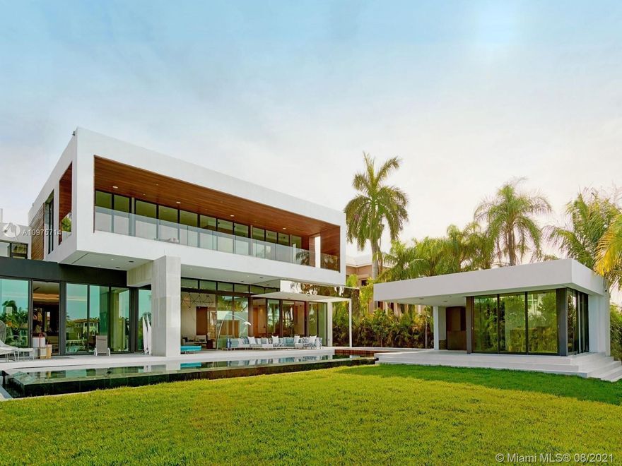 Welcome to the Newest Modern Design on Prestigious Palm Island. Upon entry to this 8 Bed/8.5 Bath home, you are greeted by vast open living spaces tastefully furnished by world renowned brand Roche Bobois & seamlessly integrating the indoor/outdoor living and entertaining. Spacious 1st floor features open chef & prep kitchens, formal & informal dining rooms, movie theatre & guest suite. Head upstairs by custom glass staircase or elevator & be greeted by the Master Suite w/ sweeping water views & an open flow with dual vanities & showers, floating tub, custom walk-in closets & midnight bar. Enjoy seclusion of backyard featuring an infinity-edge marble pool & jacuzzi, summer kitchen & cabana w/ sauna overlooking 100 Ft of WF. Guest House, 6 Car Garage, SAVANT smart- home, & rooftop lounge.
