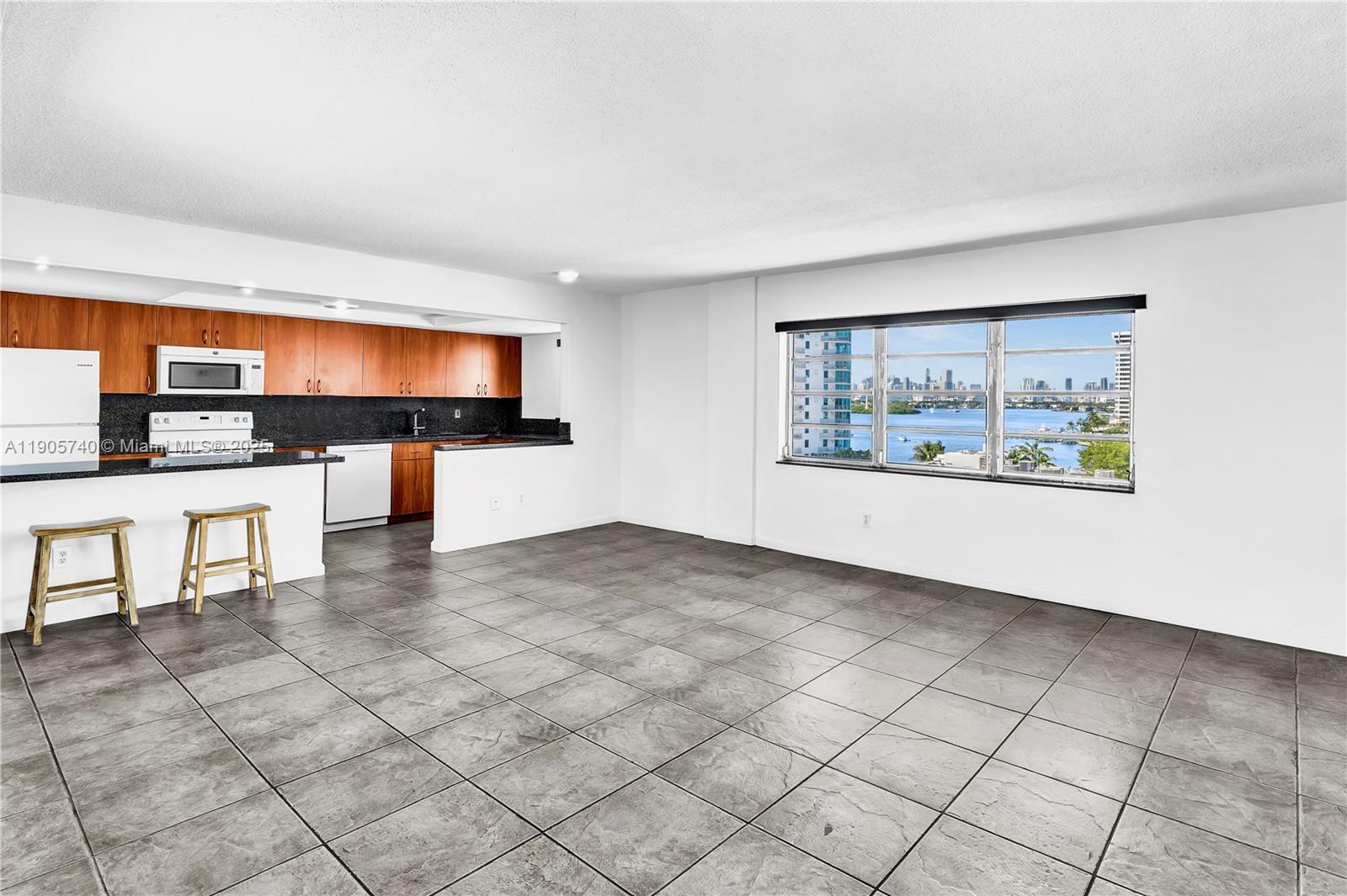 Ideal South Beach Location - Lincoln Road @ Bay Rd with covered parking spot. Oversized 847 Sq ft Top Floor Corner unit featuring an Open kitchen to loft like living/dining area w/spectacular Bay & Skyline views from every room. Completed recertifications & no assessments ~ reserves included in low maintenance fee. Large kitchen with spacious granite countertops. 1 large walk-in closet & one large bedroom closet with added shelving. Bright unit with fantastic Cross Breeze & large corner terrace. Secured building with gated, covered parking spot & pool. Prime access to all Lincoln Rd restaurants & shopping, Trader Joe's, Whole Foods; Sunset Harbor, Post Office/Fedex, etc. 20 min to MIA.