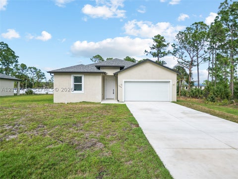 Photo of 566 Woodview Dr, Lehigh Acres, FL 33972 (MLS # A12107420)