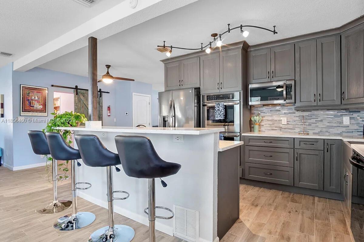 Move-in Ready in Wilton Manors West! Completely remodeled in 2019 with over $100K in upgrades, this 3BR/3BA home is turnkey perfection. Features impact windows & doors, tile floors, and a custom chef’s kitchen with island cooktop, double ovens & under-counter ice maker. Open-concept great room includes a unique indoor grill with vent system. Recent updates: new AC, water heater, appliances & electrical panel. Enjoy a lush, fenced backyard with room for a pool, avocado & banana trees, patio, concrete shed & multi-zone sprinkler system. Circular driveway with carport. Pre-inspected buy with confidence!