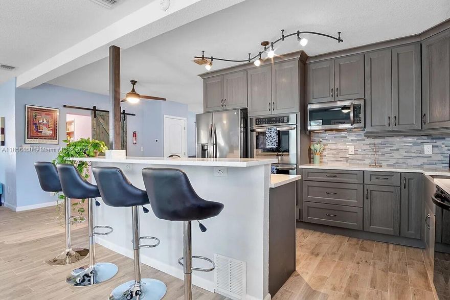 FULLY PERMITTED Move-in Ready in Wilton Manors West! Completely remodeled in 2019 with over $100K in upgrades, this 3BR/3BA home is turnkey perfection. Features impact windows & doors, tile floors, and a custom chef’s kitchen with island cooktop, double ovens & under-counter ice maker. Open-concept great room includes a unique indoor grill with vent system. Recent updates: new AC, water heater, appliances & electrical panel. Enjoy a lush, fenced backyard with room for a pool, avocado & banana trees, patio, concrete shed & multi-zone sprinkler system. Circular driveway with carport. Pre-inspected buy with confidence!