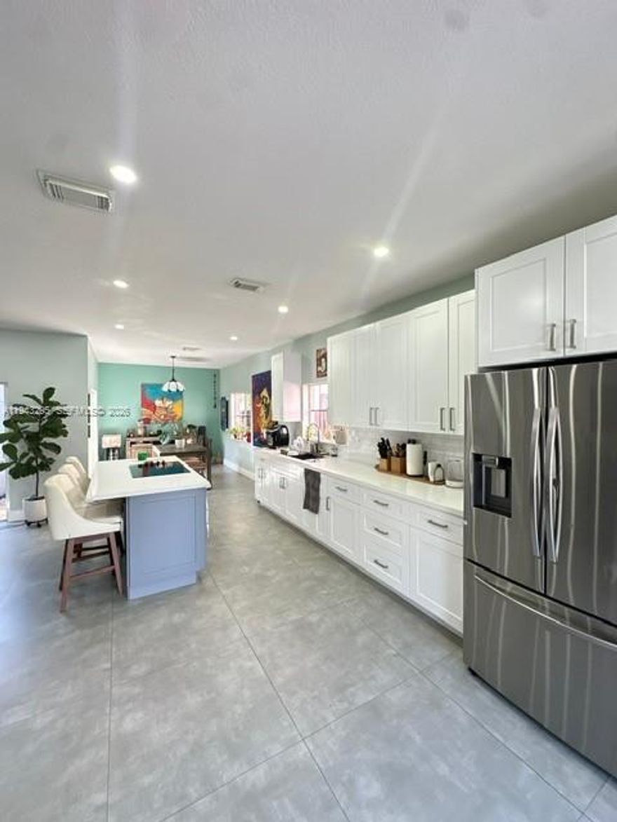 Beautifully maintained single-family home situated on a desirable corner lot in the sought-after Silver Palms community in Miami. This one-story residence offers 4 spacious bedrooms and 2 full bathrooms, ideal for families or buyers seeking comfort and functionality. The home features a large private patio, perfect for outdoor entertaining, future pool potential, or family gatherings, along with a 2-car garage and paved driveway providing ample parking. The kitchen was fully renovated in July 2022, showcasing modern quartz countertops, soft-closing wood cabinets and drawers, and brand-new stainless-steel appliances. The living areas, kitchen, and dining room are enhanced with elegant 24x24 Italian tile flooring, creating a clean and contemporary look throughout the main spaces. Major systems have been well maintained, with the AC replaced in 2019 and the water heater installed earlier this year, offering peace of mind to future owners. Located in a well-kept community with low HOA fees of only $65 per month.