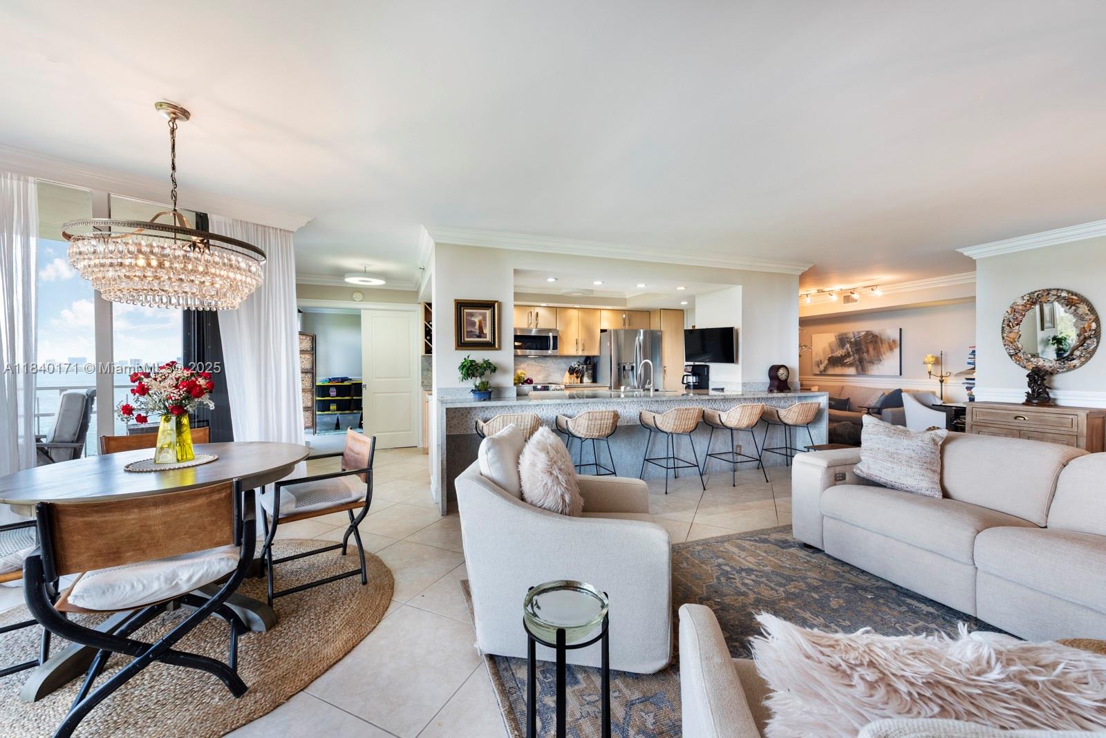 Step into one of the most uniquely designed homes in this sought-after bayfront community just outside Miami Shores. Priced below similar units, this rare gem features a one-of-a-kind floor plan with a split-bedroom layout, open kitchen, and second bedroom that opens to the living area. Enjoy serene views of Biscayne Bay, gardens, and waterfalls in a lush, resort-style setting. Inside, Arts and Crafts-inspired details include chair rails and elegant ceiling moldings. Includes full-size washer/dryer—rare for this layout. Set on 32 acres with pools, spa, gym, dining, parks, and 24/7 security. This home offers comfort, style, and convenience in one of Miami's most beautifully landscaped communities. Don’t miss this chance to own in a secure, amenity-rich enclave just minutes from everything.