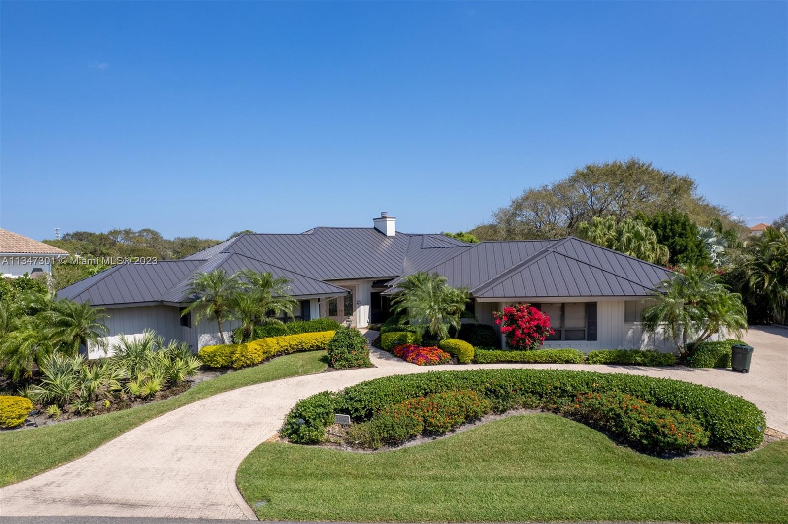 This magnificent home with 4 BR 4 BTH plus private library (4571 square feet) is nestled on the prestigious Jupiter Hills golf course. Panoramic views overlooking the world renowned Village course (#5 fairway, #17 green & lake, #4 green). Enjoy sunrises and cool evening breezes on your cozy pool/patio areas. Enjoy lush landscaping and gardens. New roof 2021, new A/Cs 2021, primary bath and closets recently renovated. Simply a prized location. This one will not last, make your appointment today!
