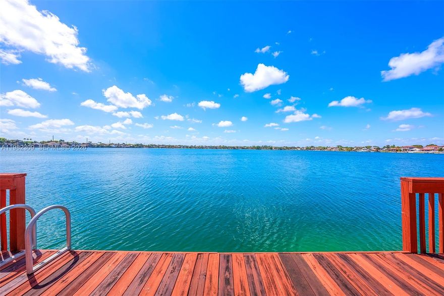 Enjoy a rare Miami lakefront lifestyle in the guard-gated community of Three Lakes, one of the few Miami communities allowing motorboats up to 20 feet. Ideally positioned on a desirable open section of the lake, this 4-bedroom, 2.5-bath residence has been lovingly maintained by its original owner.

Upon entry, a bright double-height living room welcomes you with abundant natural light and beautiful views of the lake. The kitchen features a breakfast nook overlooking the water, while the backyard and private dock provide peaceful waterfront living with direct access to boating and swimming.The main level also includes a convenient half bath, a laundry room with sink, and a 2-car garage.Upstairs features all four bedrooms, including a spacious primary suite with private balcony overlooking the lake, walk-in closet, and a generous bathroom.Residents enjoy excellent amenities including 24/7 guard-gated security, clubhouse, fitness center, community pool, tennis and pickleball courts, and lake access. Well located near abundant shopping, dining, and everyday conveniences.