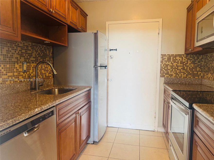 Move in ready 2/2 in nice area of North Miami. Well maintained apartment features kitchen with SS appliances, solid counters and backsplash. Primary bedroom has full wall closet and glass enclosed shower. This open concept unit is fully tiled and has balcony with a street view. Building has pool and gym and is located beside a canal with docking facilities. One assigned parking. Close to park and some stores. Near to Aventura Mall and many other facilities and services.