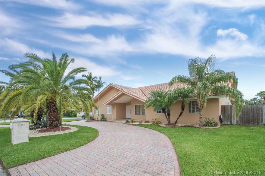 See and fall in love with this Stunning, five bedroom estate home on a spacious corner lot in the desirable Falls area.   Great layout with a comfortable, updated, eat-in kitchen with wood cabinets, granite countertops and newer appliances.  Kitchen opens up to large family room with surround sound, great for entertaining.   Updated Bathrooms including a Cabana bath, High Vaulted Ceilings, Fireplace, Central Vac, Custom molding throughout, Two Car Garage, Accordion Shutters and much more makes this a amazing family home.   Kitchen and family room open up to a huge covered  terrace overlooking a refreshing (salt water system) pool, surrounded by paved deck and landscaping.   Yard is spacious and private, Plenty of space for RV or boat.  A must see, easy to show.