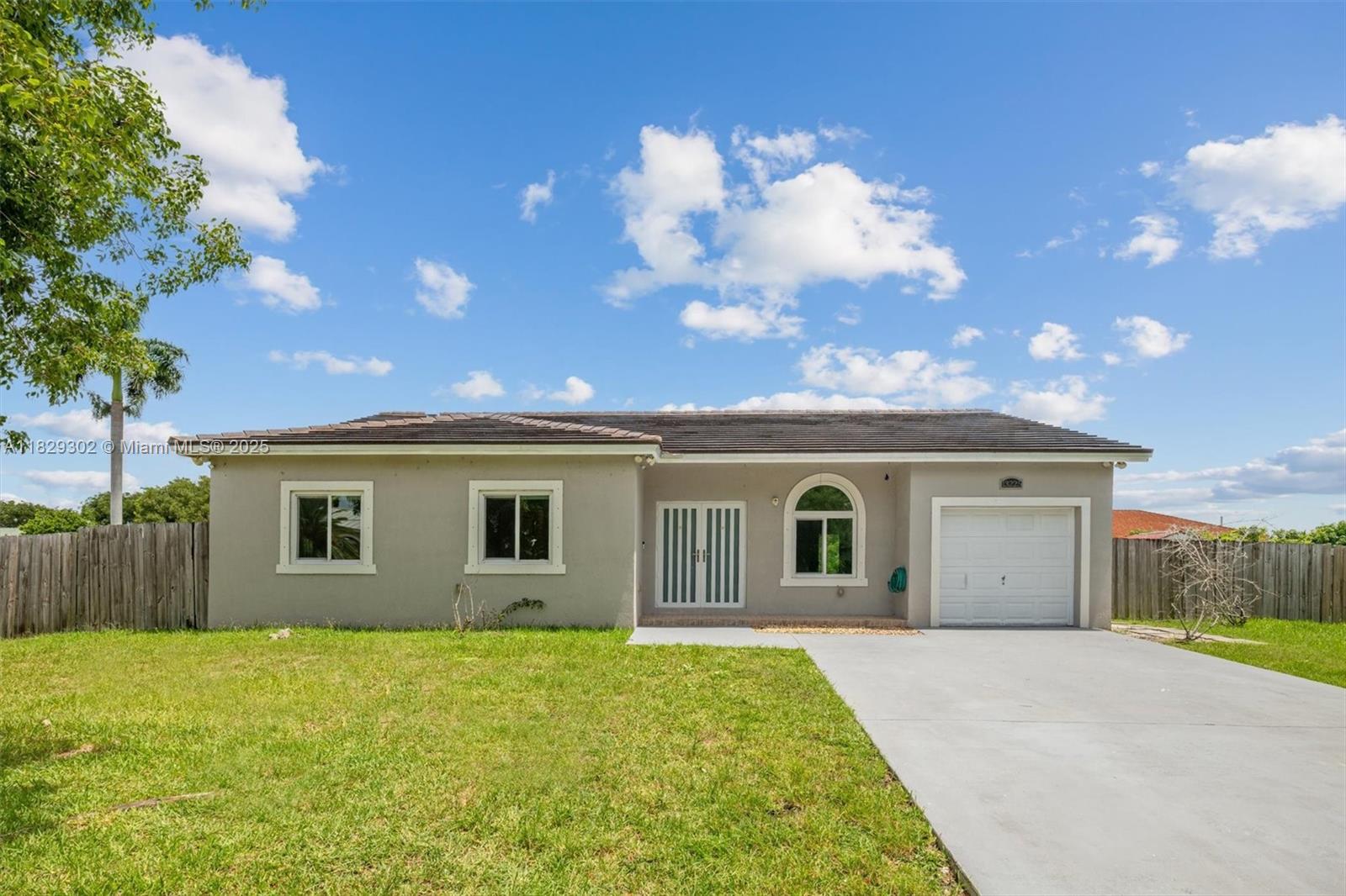 Impeccable Home on Oversized Lot – No HOA. Beautiful single-family home in a quiet, desirable neighborhood. Features 4 bedrooms, 2 bathrooms, a separate laundry room with washer and dryer, and a one-car garage, ready to build an efficiency. Impact windows and a new tile roof offer peace of mind. The kitchen overlooks the yard and includes granite countertops, wood cabinets, stainless steel appliances, and a wine cooler. Sitting on a fully fenced 16,425 sq. ft. lot, the backyard offers fruit trees and plenty of space for a pool, guest house, in-law suite, boat, RV, or tiki hut. Additional features include a water softener system and no HOA. Conveniently located near major supermarkets, schools, churches, highways, and with easy access to the Florida Keys. Must see! Call listing agent.