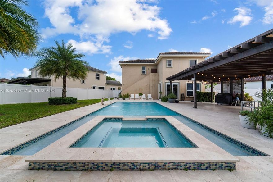 Entertainer’s Paradise on one of the LARGEST lots in Kendall Square! This exquisite 4-bed, 4-bath single-family residence boasts over 2,600 sq ft of modern elegance. Featuring a gate in the fence to bring in your boat or RV, you will enjoy the meticulously designed pool and jacuzzi, covered pergola, full cabana bath, and plenty of space for outdoor entertaining. This 'Next Generation' model has a complete guest suite with refrigerator, stove, sink, dishwasher, microwave, and its own W/D, which may be used as a separate apt for RENTAL INCOME, as part of your own 4/4, or as guest quarters. Nestled on a peaceful cul-de-sac across from a huge sparkling lake, this home is in a top-rated school district, has a low monthly HOA, a 2-car gar, accordion shutters, and a fully equipped fitness center.