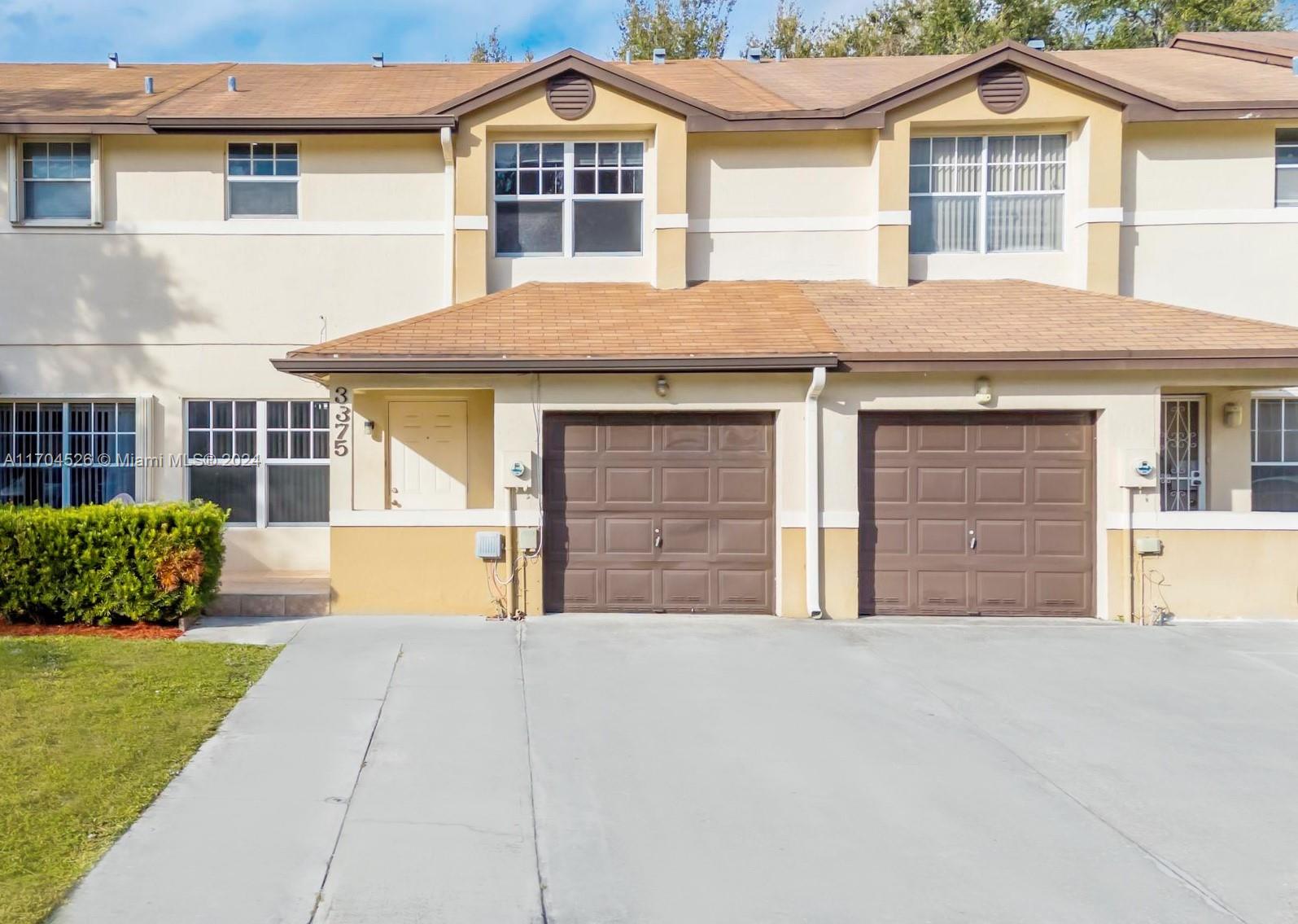 Welcome to this beautifully updated 3-bedroom, 2.5-bathroom townhouse in a secure gated community. The open-concept layout features a modern kitchen and a primary suite with a walk-in closet, tub, and shower. Enjoy peace of mind with all-impact windows and a roof installed in 2016. The first floor boasts new laminate flooring, while the second floor is adorned with tile. Step outside to your private backyard, which backs onto a spacious community green park, perfect for relaxation. The large driveway and attached 1-car garage provide ample parking. Conveniently located near the Turnpike, commuting to South Miami and Broward County is a breeze. Plus, you're just moments away from the excitement of Hard Rock Stadium. Don't miss the opportunity to make this quiet neighborhood your new home!