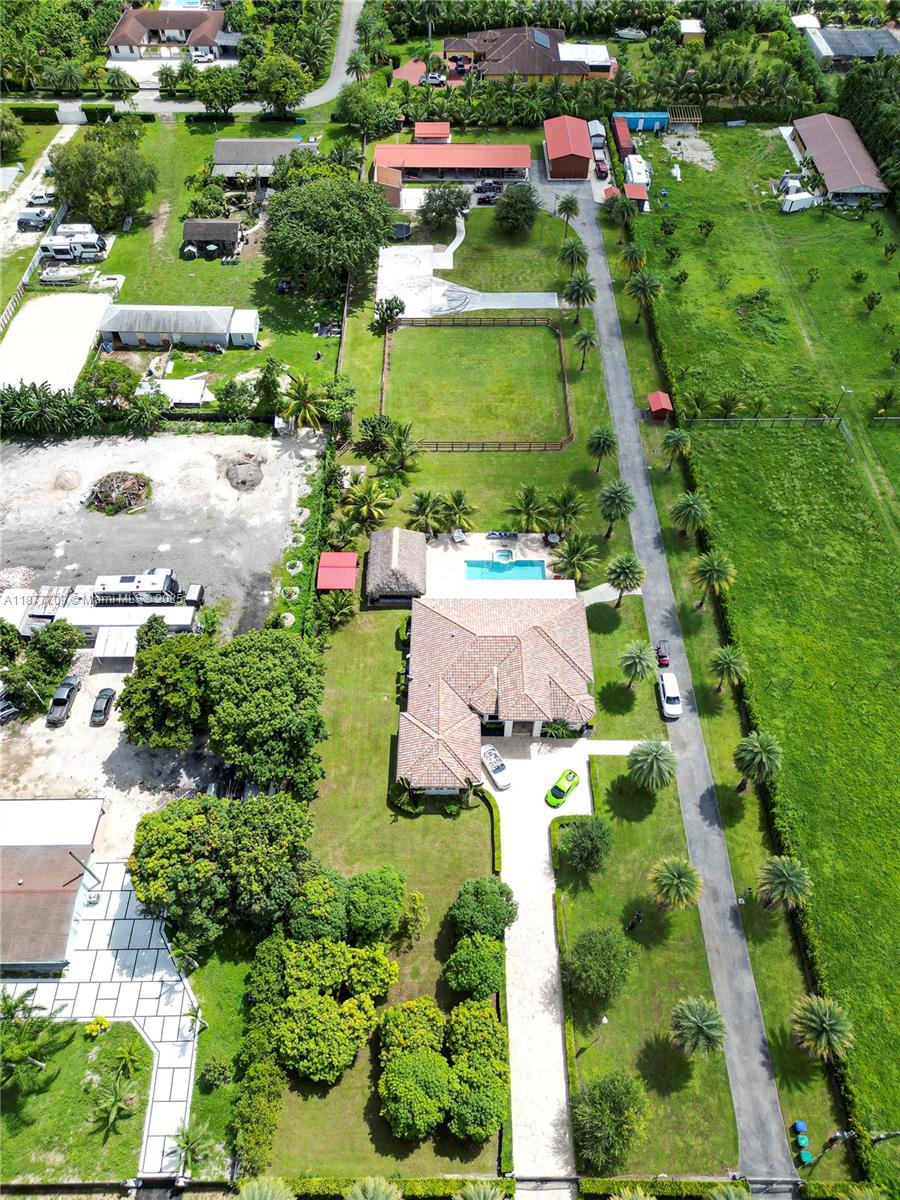 WELCOME TO THE TRANQUILITY OF THE REDLANDS! BEAUTIFUL CUSTOM BUILT IN 2016 ESTATE FEATURING 3/3.5 WITH A 1/1 GUEST HOUSE ON A 2.42 ACRE LOT. OPEN FLOOR PLAN, SPACIOUS MASTER SUITE WITH CUSTOM CLOSETS, 8 FT SOLID WOOD DOORS, HIGH CEILINGS WITH CUSTOM LIGHTS AND LAMPS, GOURMET KITCHEN WITH HIGH END APPLIANCES, QUARTZ COUNTERTOPS, ISLAND, HIGH END CABINETRY, QUALITY SURROUND SOUND SYSTEM, SECURITY CAMERAS AND LIGHTING THROUGHOUT THE PROERTY. IMPACT WINDOWS AND DOORS, 2 CAR GARAGE WITH INSULATED DOORS AND CUSTOM CABINETRIES, FULL POWER 50K DIESEL GENERATOR WITH 300G FOR FUEL INST 2019. HEATED POOL WITH JACUZZI, TIKI HUT, RACKET BALL COURT, OVERSIZED GYM, 3 WELLS, SPRINKLERS 9/SECTIONS, 4 HORSE STABLES, FANS, FLY SPRAY SYSTEM, WASH DOWN STATION, VARIOUS TYPES OF FRUIT TREES AND MORE. MUST SEE!