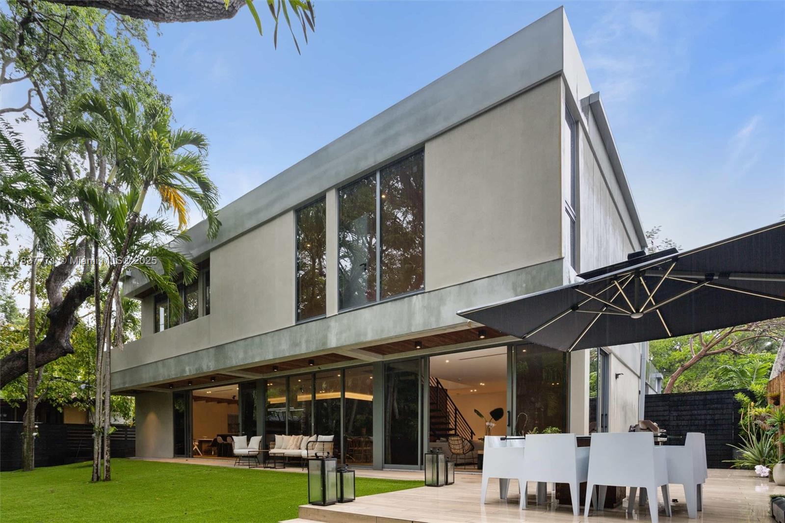 Experience modern luxury in this 5-bedroom, move-in-ready home located in the heart of Coconut Grove. Designed with an open-concept layout, the living areas connect naturally, perfect for both relaxed gatherings and upscale entertaining. The chef’s kitchen features premium appliances, while the spacious master suite includes a private balcony for your retreat. Each bedroom boasts its own en-suite bathroom and walk-in closet, offering comfort and privacy. Step outside to enjoy the lush tropical garden that surrounds the property. Additional highlights include a 4-car parking area and a large storage room. This residence effortlessly blends contemporary design with everyday comfort.