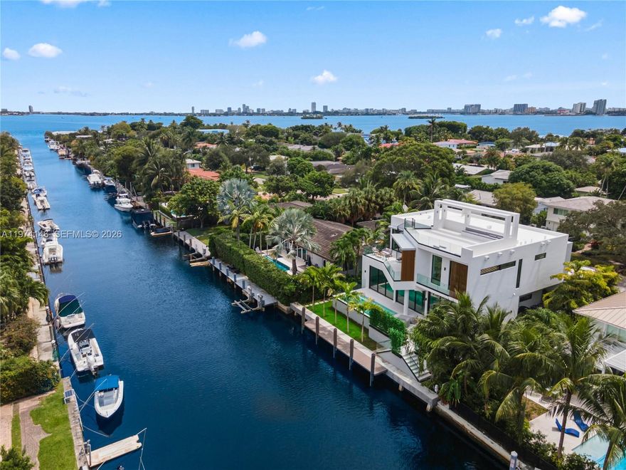 Experience luxury in this 2026 NEW CONSTRUCTION waterfront masterpiece located in exclusive Miami Shores-East. Designed by FAO Architecture and built by Barreto Constructions for Setasi Developers, this contemporary estate blends sophisticated design with serene waterfront living—just under one minute to the OPEN BAY with no fixed bridges. Offering 6,621 total Sq Ft and 4,938 Sq Ft of interior space, the residence features 4 bedrooms, 4.5 designer baths, a fully integrated smart-home system, and an Italian Mia Cucina kitchen. The primary suite offers a private terrace, dual walk-in closets, and a spa-inspired bath. Interior highlights include impact glass, a floating staircase, temperature-controlled wine cellar, and elegant Spanish tile finishes. Outdoors, enjoy 75 ft of water frontage, heated pool and spa, summer kitchen, expansive terraces, and a rooftop lounge with stunning sunset and Miami skyline views. Located in the sought-after Miami Shores golf community, minutes from top schools, Miami Shores Country Club, Bal Harbour Shops, and premier dining and culture. Partially furnished and move-in ready, this home delivers refined waterfront living with effortless bay access.