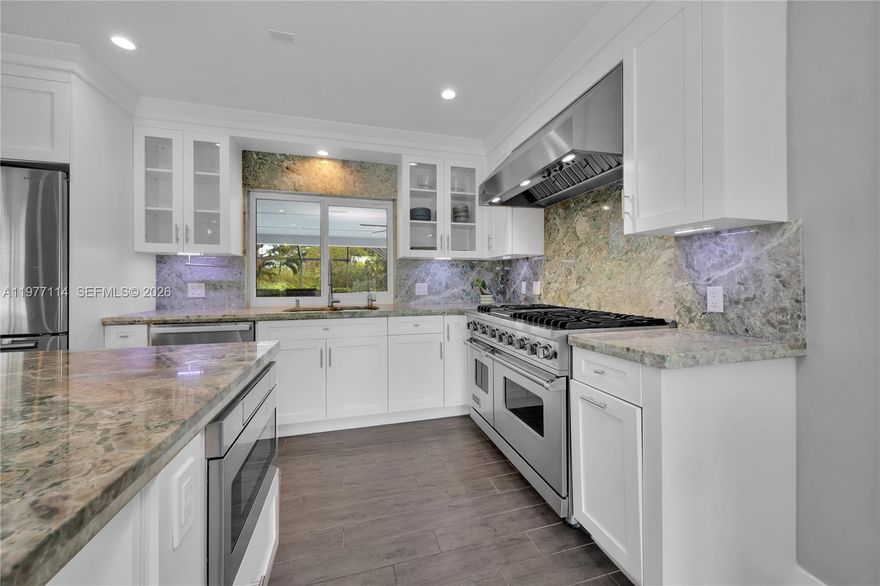 Set on an expansive 34,848 SF lot, this beautifully renovated and fully gated 4 bed 2 bath home offers a rare sense of space, privacy, and seclusion. Inside, the home features a convenient floor plan with bright open living space, impact windows and doors, upgraded flooring, custom closets and a multi-use 2 car garage. The chef’s kitchen is equipped with a Viking 6-burner gas range, double ovens, quartzite countertops, four pantries, a custom-made coffee station and a reverse osmosis system.
Outdoor living shines with a heated pool, and jacuzzi, screened lanai, covered patio, and over 2,000 SF of travertine pool deck, perfect for entertaining or relaxing. The lush grounds include mature fruit trees—lychee, avocado, two mango trees, star fruit, and banana trees, creating a true backyard oasis. Plenty of room for your boat and/or RV and with easy access to Biscayne National Park, Black Point Marina, and the Florida Keys. The home enjoys a peaceful setting providing the kind of breathing room that’s increasingly hard to find, while still being minutes from main attractions and highways. Easy to show.