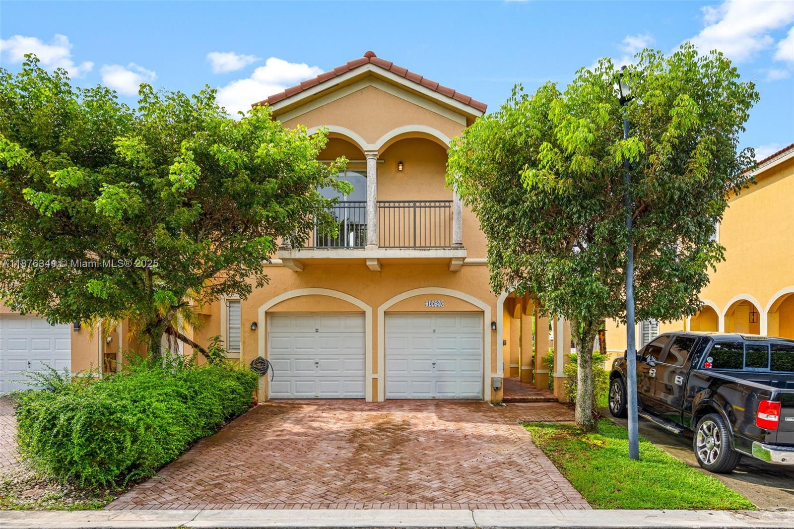 Welcome to Sunset Lake Townhomes in West Miami! This spacious 4-bedroom, 2.5-bathroom townhouse offers nearly 2,000 sq ft of living space and a desirable two-car garage. The interior has been freshly painted, features a new A/C, and boasts new luxury vinyl floors upstairs. The open floor plan connects to a private back patio with serene lake views, ideal for relaxing or entertaining. Upstairs, the bedrooms are generously sized, offering comfort and flexibility for today’s lifestyle. With its size, layout, and waterfront setting, this residence truly feels like a single-family home.