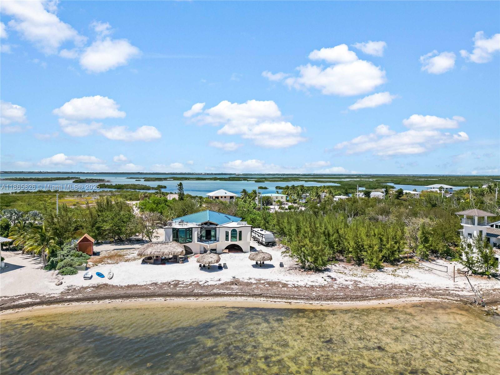 The Barnacle Bed and Breakfast is a historic waterfront estate on 6± acres in the Florida Keys, offering a rare combination of investment and lifestyle opportunity. Located on scenic Coupon Bight, the property features direct oceanfront with a private beach, bayfront access, a private boat ramp, and CBS dockage. Three buildings plus a fixed trailer are included, fully furnished, with indoor and outdoor kitchens, electric, and central water on site. Currently operating as a successful bed and breakfast with daily hotel rates, it provides strong income potential or can be converted into a private compound or luxury estate. With 360-degree water views and expansive outdoor spaces, this historic property is a once-in-a-lifetime opportunity to own a true jewel of the Florida Keys.