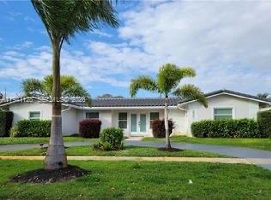 Spacious 4-bed, 3-bath home featuring impact windows, tile flooring, and an open-concept kitchen with contemporary finishes. Enjoy your private swimming pool—ideal for entertaining and relaxation. The property includes a generous yard with rear alley access, providing ample space for a boat or RV. Conveniently located near beaches, restaurants, and major roadways. Move-in ready!