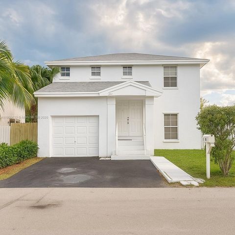 Photo of 5916 Woodland Point Pl, Tamarac, FL 33319 (MLS # A11905632)