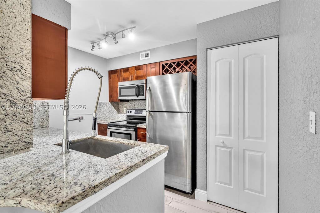Photo of 2851 N Oakland Forest Dr #111, Oakland Park, FL 33309 (MLS # A12049654)