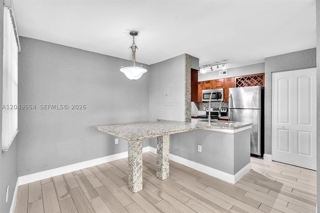 Photo of 2851 N Oakland Forest Dr #111, Oakland Park, FL 33309 (MLS # A12049654)