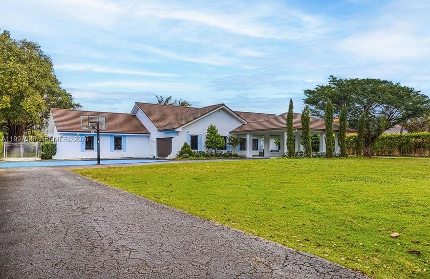 Stunning gated estate on 1.5 acres of private grounds, ideal for family living and entertaining. Expansive living areas feature 4 bedrooms, 3 full baths, and 2 powder rooms. Newly redesigned gourmet kitchen with Viking appliances, electric cooktop, double ovens, ice machine, 2 refrigerator drawers, and dual islands. Accordion doors open seamlessly to a resort-style pool area with pergola, sauna, and a unique freestanding English-style pub. Additional highlights include a 2-car garage, a large room with potential to be incorporated into the primary suite, new roof, impact-resistant windows and doors, and a whole-house water filtration system. Exceptional privacy, space, and lifestyle in a truly special property.