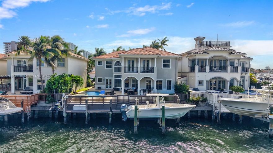 Nestled on a waterway with direct ocean access in an exclusive cul-de-sac, this stunning estate features a heated pool, spa and both a boat and Jet Ski lift for the ultimate waterfront lifestyle. Spanning approximately 5,000 sq ft, this luxurious 6 bedroom and 5.5-bathroom home features a gourmet kitchen with top-tier Thermador appliances, double oven, induction cooktop, Sub-Zero fridge/freezer, and a built-in wine cooler. Summer kitchen and 3-car garage with a Tesla charger add to the convenience. Residents enjoy access to the prestigious amenities of Harbor Islands, including tennis, Pickleball, a state-of-the-art gym, marina, parks, and playgrounds. Just moments from the beach, world-class shopping, fine dining, and places of worship, this home offers the epitome of refined living.