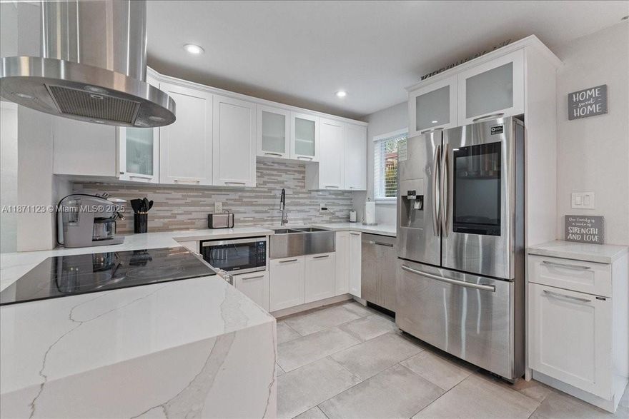 FULLY PRE-INSPECTED, Move-In Ready, and Loaded With Upgrades! This Wilton Manors Corner-Lot Retreat Features Impact Windows and Doors, 2019 Flat Roof, Tankless Water Heater, and Updated Systems. Inside, Porcelain Tile Flows Into an Open Kitchen With Quartz Countertops, Custom Cabinetry, and Premium Appliances. The Expansive Primary Suite Offers Dual Climate Zones, Walk-In Closet, And Spa-Style Bath With Wet Room, Multifunction Shower, And Hydrotherapy Microsilk Tub. A Bright, Seamless Layout Enhances Everyday Living, While Natural Light Warms Each Room. Enjoy Outdoor Living With Pergola-Covered Patio and Dual Driveways For Cars, Boats, Or RVs. Modern Elegance Meets Tropical Living In the Heart Of Wilton Manors, Just Minutes From Beaches, Dining, and Entertainment!