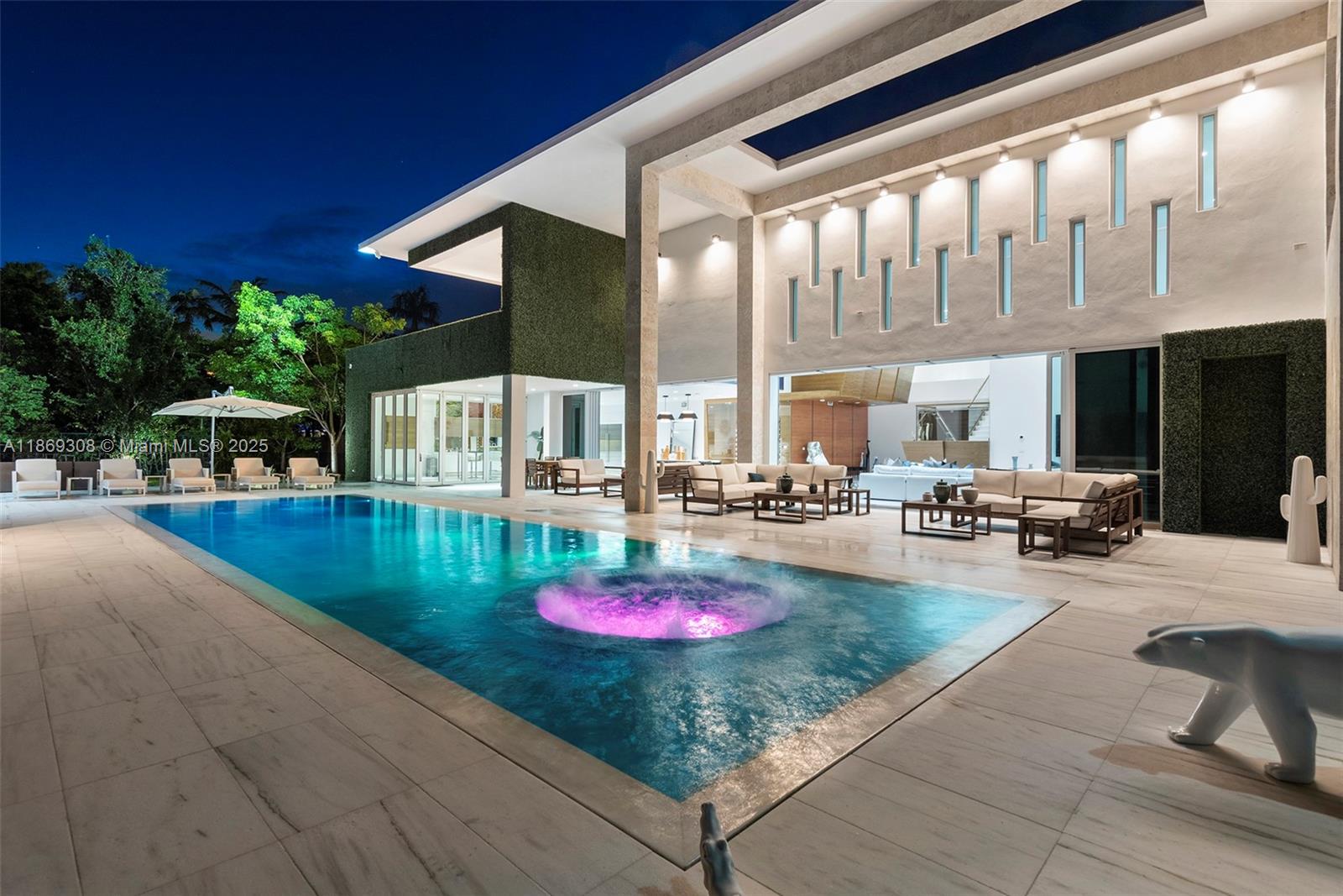 Luxury estate in South Miami, set on over an acre. This modern masterpiece blends elegance with nature, featuring a zen forest entryway and expansive glass walls that highlight tranquil water views. Newly completed with smart home tech, high-end finishes, a media room, gym, and two driveways. The Dada Italian kitchen with Wolf and SubZero appliances is a chef's dream.
The two-story home has 6 bedrooms, each with an en-suite bathroom, including a 1,300 SF primary suite with wraparound windows, sitting area, spa bath, and walk-in closet with laundry. Enjoy seamless indoor/outdoor living with 50' sliding doors leading to a 75' infinity pool, jacuzzi, outdoor living rooms, summer kitchen, fire pit.
Available for Seasonal, Monthly, Weekly. FOR RENTAL RATES, PLEASE CONTACT LISTING AGENT.