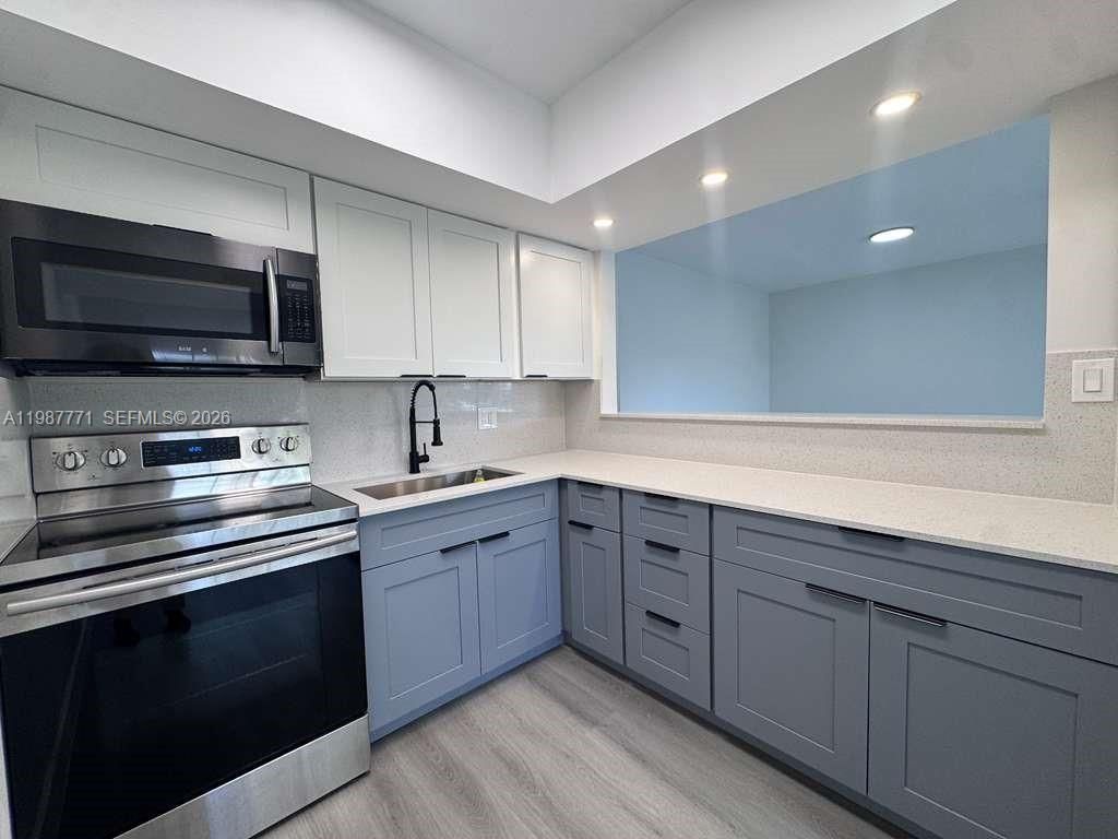 Photo of 455 Golden Isles Dr #203, Hallandale Beach, FL 33009 (MLS # A11987771)