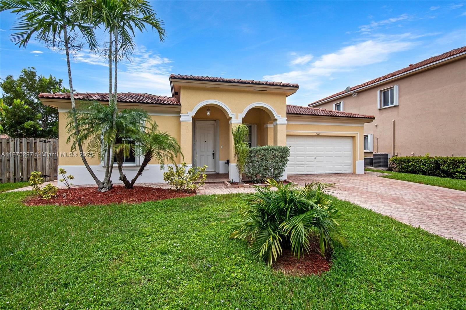 Spacious 4 bedrooms, 2.5 bathrooms home on a corner lot in the gated community of Floridian Bay Estates at Waterstone. This one-story residence features a two-car garage, tile floors in living areas, wood laminate in bedrooms, accordion hurricane shutters, and an extra refrigerator in the garage included in the sale. The open kitchen offers granite countertops and a breakfast area, while the fenced backyard includes space for a boat, a mature mango tree, a brick-paver driveway, and a brick-paver patio. Freshly painted and move-in ready. Waterstone offers lakes, walking paths, a clubhouse, and resort-style amenities, all with easy access to the Turnpike, schools, shopping, and dining.