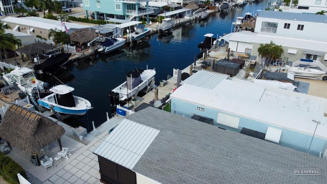 Key Largo waterfront home ready for its new owners. Located in the Cross Keys neighborhood first canal with access to bay direct access to Adam's Cut. Move in ready 2/2 with concrete dock and 10K boat lift. Corner lot with expansive parking. Laundry room and exterior storage shed Tiki hut all paved backyard ready to enjoy afternoons with amazing water views. Close to restaurants, shopping and quick commute to Miami.