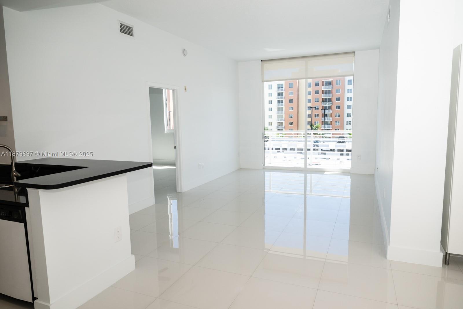 Spectacular Remodeled Penthouse in The Venture at Aventura West! Bright and spacious 2 bed / 2 bath with soaring ceilings, open kitchen with black granite countertops, white tile floors, waterproof vinyl in bathrooms, and split floor plan. Features brand-new bathrooms, new A/C, new water heater, washer/dryer in unit and generous closets. Enjoy private balcony with pool views. High-impact windows. 1 assigned garage space + Valet Parking. Luxury building with no assessments, 24-hr concierge/security, 2 infinity pools, cabanas, sauna, spa, fitness center, business center, theater room & more. Prime location near Aventura Mall, dining, shopping, and beaches. Excellent for investment or owner-occupied. Walk to supermarkets, cafes, parks, and enjoy the vibrant Aventura lifestyle. Easy to show!