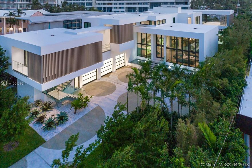 Brand new, ultra-modern home boasting 8,910 SF of exceptionally designed luxurious living space flawlessly connecting with the exterior. Inside, an incredible living room with dramatic 16-foot ceilings, sited next to the courtyard – a formal dining with a temperature-controlled wine cellar with an entire wall of marble, & glass-enclosed waterfront family room with an open Poliform Kitchen & island. Wood floors throughout, all marble baths, elevator, office room, separate guesthouse, & more. Upstairs, dreamy master with walk-in Poliform closet, private terrace, luxe marble bath, & private staircase to the pool deck. Exterior: pool, Jacuzzi, summer kitchen, covered terraces, new seawall/dock, 3-car garage. 17,702 SF lot, 80 FT waterfront, total area 11,137 SF. Developed by On One Group.