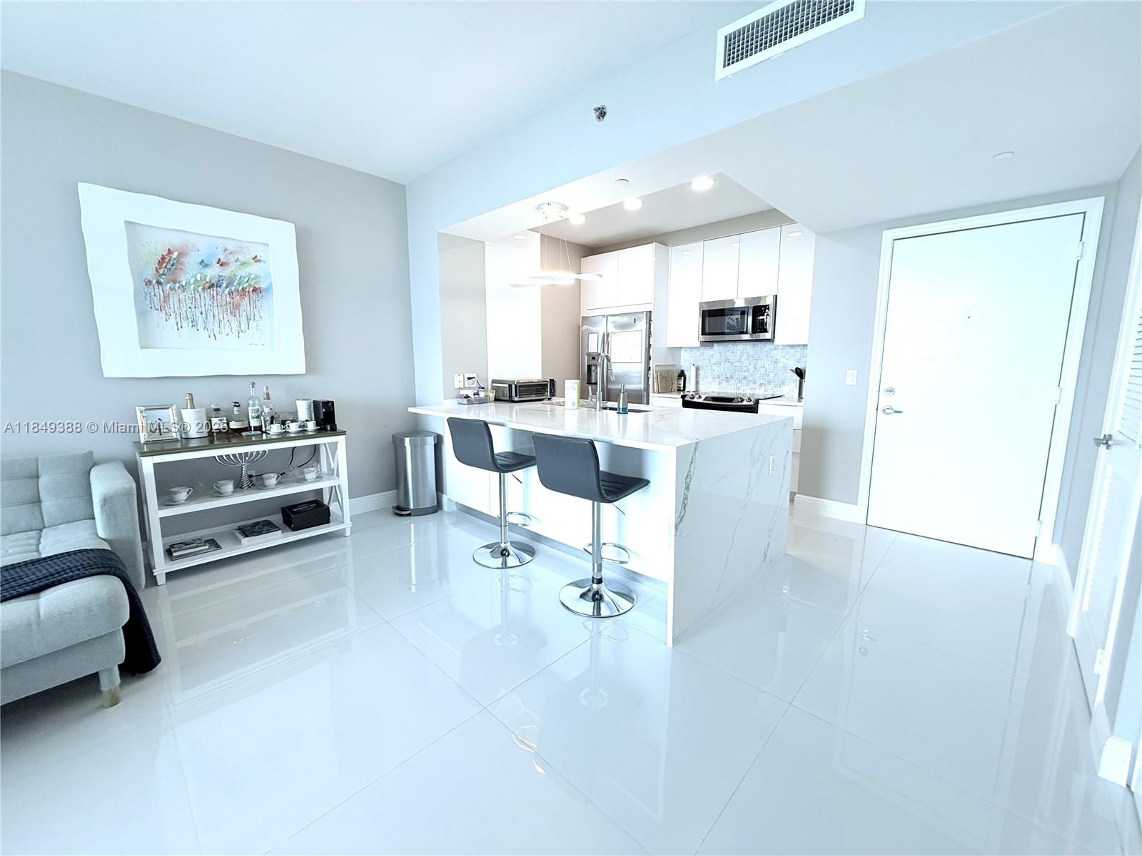 Experience unparalleled luxury in this spectacular 34th-floor, 1-bedroom, 1-bathroom unit offering direct Biscayne Bay views. This residence boasts brand-new flooring and a remodeled kitchen and bathroom featuring modern stainless steel appliances, sleek countertops, and contemporary cabinetry. Enjoy an array of world-class amenities including 24-hour security, concierge, and valet parking, state-of-the-art fitness centers in each tower, two infinity-edge heated pools, a steam room, theater room, business center, party room, and a pool table lounge. Perfectly situated for urban living, you're just a short walk from Mary Brickell Village and Brickell City Centre mall. Water, basic cable, and internet are included, along with one assigned parking space.