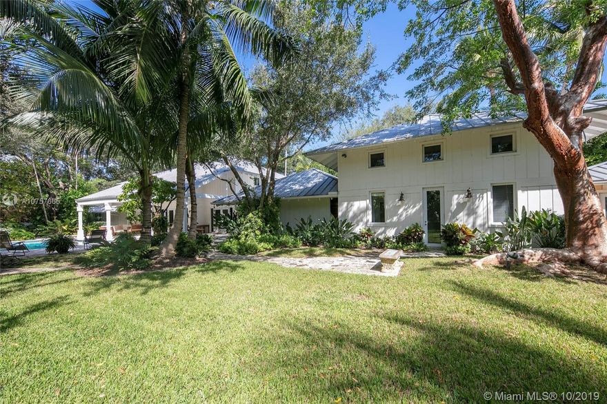 Gorgeous Florida Vernacular on an Oak, Gumbo Limbo, & fruit tree studded 37,462 sf lot in Ponce Davis trophy location cul de sac of only 3 homes. Lush landscape, verdant views make this home a daily retreat. Many updates in 2012/2014, Limestone & wood floors, impact windows/doors, chefs kitchen w/gas Wolf stove, espresso machine, wine cooler. Double height entry atrium lit by a skylight. Living, breakfast & family rms all open to large covered terrace, pool,yard. Coralina walkways to a chickee hut & N-S tennis court. Downstairs master wing open to the terrace, enjoys an office, his/hers walk ins & glamorous bath suite. Staff area & guest/in-law w/an exterior door. Gym loft, laundry/staff area. 2 upstairs Jack & Jills w/vaulted ceilings. 2 car garage can accommodate lifts. 3 guest prkg bays