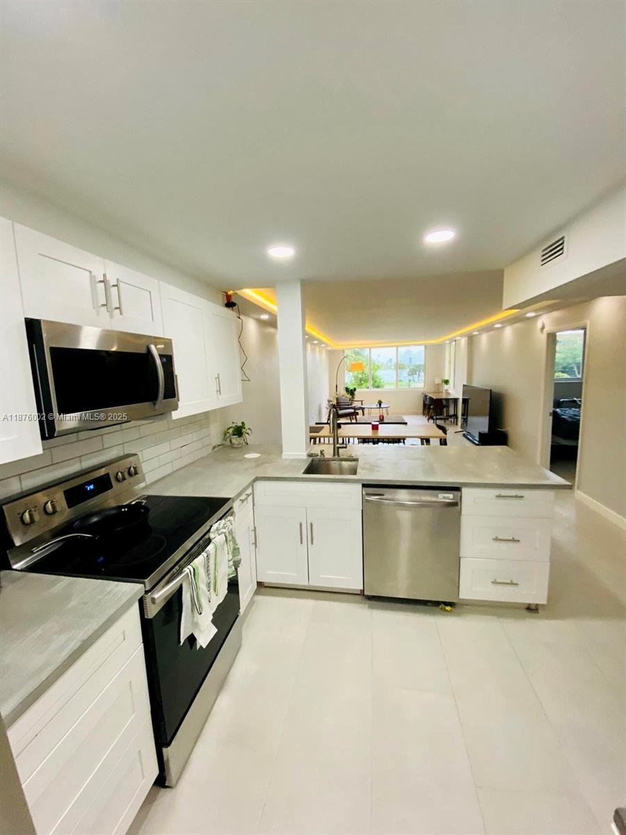 FULLY REMODELED 1 BED 1.5 BATH the community of Royal Oaks. This turn-key apartment has brand new modern kitchen cabinets, stainless steel appliances, and a new AC (2024). Comfortable living space with lots of natural light and additional storage. Bedroom features walk-in closet. Unit features a pleasant view to the community swimming pool and greenery. Amazing location, only 4 miles from Aventura Mall and just few miles to I95. One assigned parking spot and ample guest parking. No rent for first 2 years. *Currently rented month-to-month, Buyer may inherit tenant!