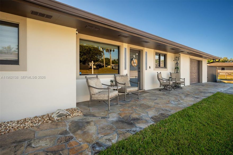 Welcome to a corner-lot home that immediately feels cozy, welcoming, and thoughtfully cared for. As soon as you step inside, the wood ceiling sets the tone, creating a sense of calm and comfort that makes the home feel inviting and grounded. It’s the kind of space where you instantly feel at ease.
Mature tropical landscaping and fruit trees frame the property, offering a private outdoor retreat perfect for relaxing or entertaining. Enjoy gatherings under the custom tiki hut, surrounded by lush greenery that captures the essence of South Florida living.
The open-concept layout flows seamlessly into a spacious family room, ideal for hosting or everyday living. The kitchen connects effortlessly to the main living areas and offers generous counter space, truly serving as the heart of the home. A large laundry room adds functionality, while the remodeled primary bathroom and expansive primary closet elevate comfort and convenience.
Several impact windows and doors provide added peace of mind. The property offers ample space for an RV, trailer, boat, or additional vehicles, along with a newer outdoor storage shed for added storage. No association, allowing flexibility and freedom of ownership. Most of the furniture is available for purchase, offering a convenient move-in option. You can feel the care and attention poured into the details of this home — with even more gems waiting to be discovered upon visiting.