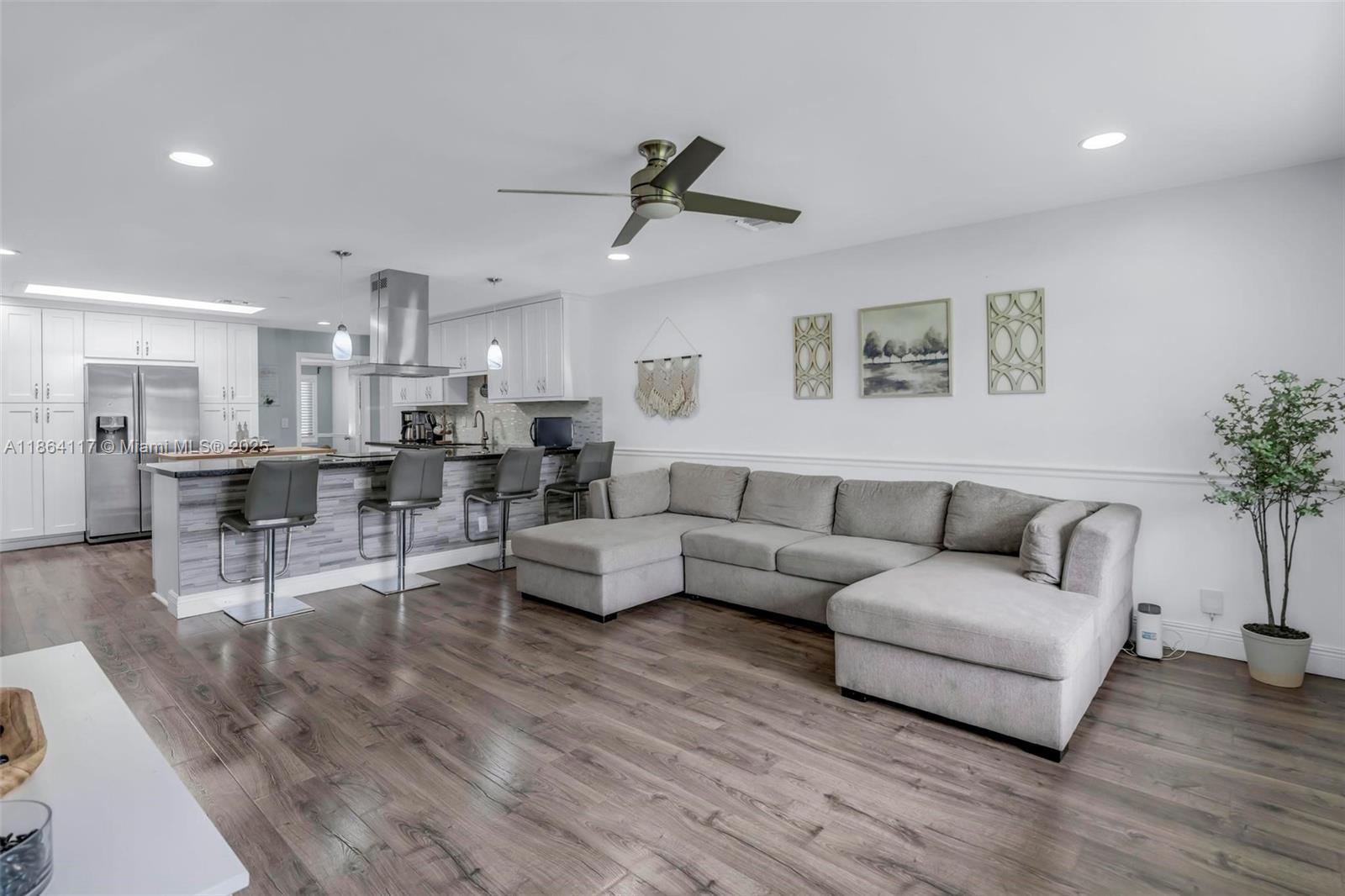 Completely remodeled 3/2 single-family home in the heart of Cooper City w/ NO HOA. This stunning residence features luxury vinyl flooring throughout, impact windows, recessed lighting, & modern zebra blinds for your convenience. The open-concept kitchen boasts sleek stainless-steel appliances, white shaker cabinets, quartz counters, & soft-close drawers. Enjoy a spacious layout w/ two living areas, one perfect for a 4th bedroom, home office, or game room. The master suite offers two walk-in closets & a resort-style bath w/ elegant finishes. Abundant natural light flows through every room. Spacious laundry room in the home for your convenience. The property is fully enclosed with PVC fence for privacy. Full 1 car garage. A covered outdoor patio with ceiling fans, perfect for entertaining.