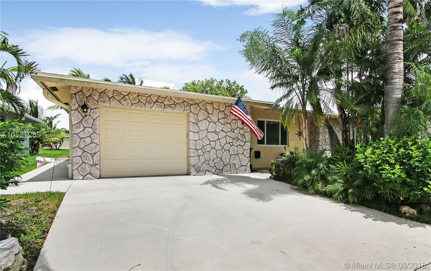 ABSOLUTELY STUNNING, HIGHLY UPGRADED PARADISE GARDENS HOME, LARGE OPEN FLOOR PLAN. LUXURY KITCHEN WITH CUSTOM CABINETRY, SOFT CLOSE DRAWERS & DOORS, UNDER CABINET LIGHTING, INTERIOR LED RECESSED LIGHTING THROUGHOUT THE HOME. COMPLEMENTING THE GRANITE COUNTERS ARE THE TOP-OF-THE-LINE APPLIANCES. NEW IMPACT WINDOWS/DOORS, PLANTATION SHUTTERS IN THE LIVING ROOM, NEW A/C, CENTRAL VACUUM, WHOLE HOUSE GENERATOR, PRIVATE DOCK, BEAUTIFULLY LANDSCAPED SURROUNDED BY EXOTIC TROPICAL TREES AND PLANTS AS WELL AS TWO SOOTHING WATER FOUNTAINS…AND SO MUCH MORE! DEFINITELY A MUST SEE!