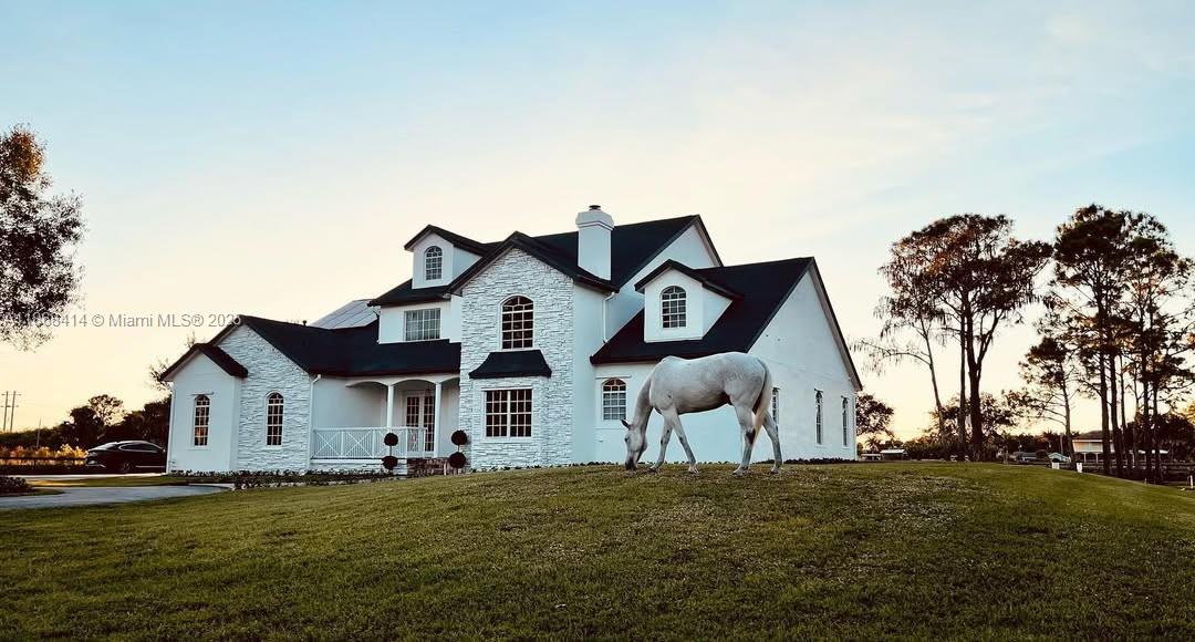 Exquisite 5-acre equestrian estate in gated Deer Run, minutes from Wellington’s top dressage venues. Renovated in 2021 & 2023 with elegant French Country design, this 5BR + den, 3.5BA, 4,334 sqft home offers refined living with formal dining, loft, and first-floor master suite. The 5-stall concrete barn features soft stall flooring, auto waterers, A/C tack & feed rooms, groom’s quarters, and 1/1 apartment. Ride daily in your Olympic-size fiber arena with irrigation and drainage, 8 lush paddocks, private trail, and dual gated entries. New roof, $150K solar system, 2-car garage, barn parking. Zoned Ag.