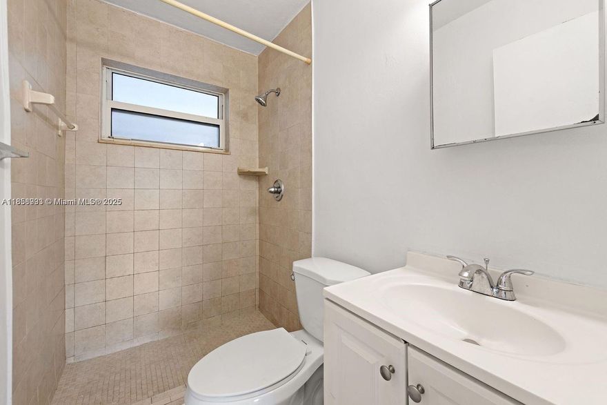 Prime Victoria Park Rental Opportunity! Charming 3-bedrooms, 2-bathrooms unit available in a quiet, well-maintained neighborhood. This freshly painted residence features tile flooring throughout, window A/C units for personalized comfort, and ceiling fans in both bedrooms and the living area. The updated kitchen offers modern cabinetry along with essential appliances, including a refrigerator and stove. The bathroom is bright and functional with a tiled shower. Multiple windows provide abundant natural light. Situated in a building with a distinctive yellow exterior, landscaped lawn, and a fenced outdoor area—ideal for relaxing and enjoying the surroundings.