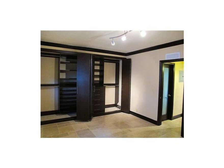 **CASH BUYER OR SELLER FINANCING**Centrally located on tree-lined street just a block from Lincoln Rd promenade & minutes from the beach. Gorgeous 1/1 unit features travertine floors, large bedroom w/wood, custom closet cabinetry including wooden (hinge & sliding) doors off ering above average storage. Custom bathroom, modern kitchen & state of the art lighting/fixtures w/small front patio, onsite parking (not assigned) & community W/D complete this gem of a unit!