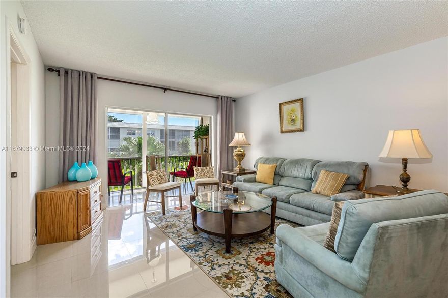 REDUCED! Welcome to your serene oasis in Sandalfoot! 2b/2b 55+ Condo filed with natural light and an inviting atmosphere. Step onto the screened balcony and enjoy peaceful views of the lake and gardens. Updated beautiful porcelain tile floors throughout. Newer AC. The spacious main bedroom suite features a generous walk-in closet and an en-suite bathroom. A large second bedroom and full bathroom, completes this thoughtfully split plan. The well-maintained community offers elevator, extra storage, and ample guest parking. Enjoy the heated saltwater pool and spa area, seen from your kitchen, perfect for relaxing days in the sun. Laundry facility steps from your door. Close to shops, grocery stores, and restaurants. Easy access to major roads and highways. The beach is only 20 minutes away!