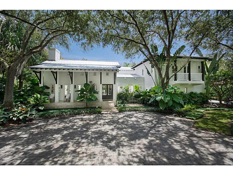 On a quiet tree-lined street in Ponce-Davis sits an incredible Plantation-style estate designed by Ramon Pacheco. The features include double-height ceilings, formal living and dining rooms, recreational room, two courtyards, and an eat-in gourmet kitche n. The luxurious master suite has a separate office/sitting room with French doors, his and her closets, and a spa-like bathroom. Enjoy entertaining family and friends on the gorgeous back patio with summer kitchen, large heated pool and Jacuzzi.