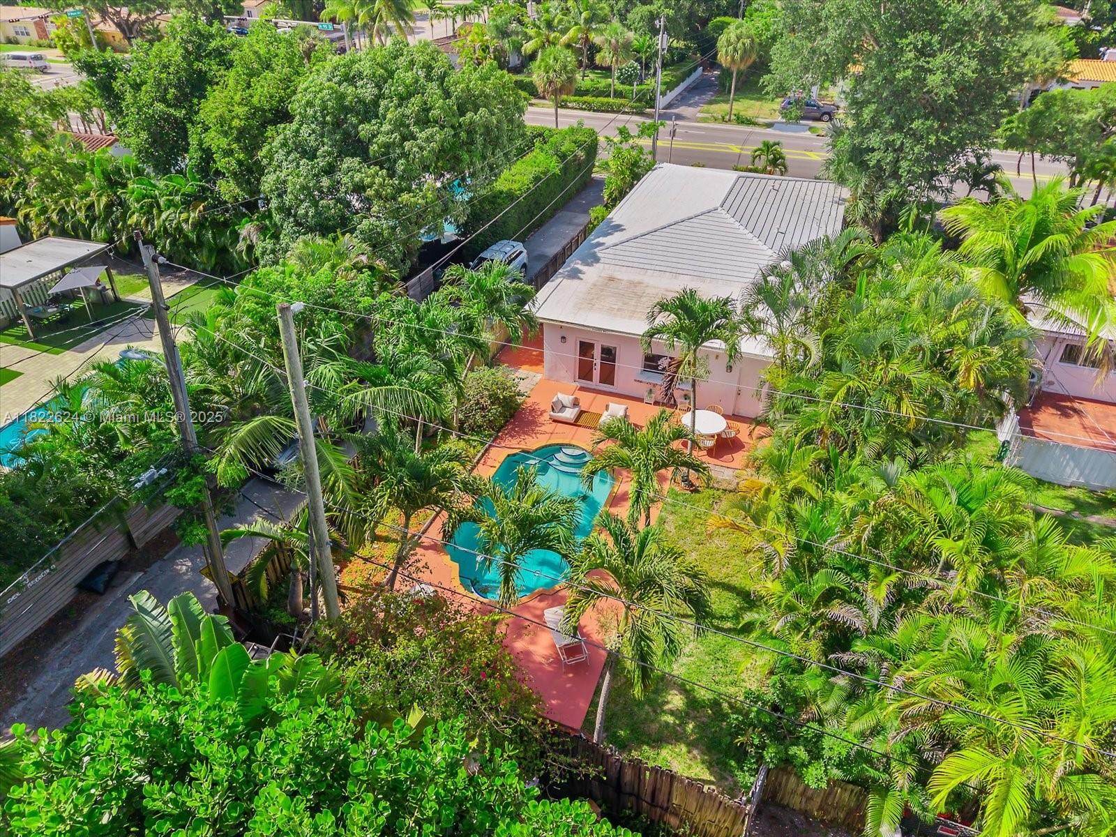 Welcome to Casa Palmera, a tropical hideaway in prime Miami Shores. This bright and airy 4-bed, 3-bath home offers laid-back luxury with a lush backyard escape, framed by swaying palms and vibrant landscaping. A sun-drenched corridor guides you through the home, connecting light-filled interiors with the outdoors. The oversized kitchen is the heart of the home, featuring a generous snack counter and a large dining area that opens directly to the patio, perfect for effortless indoor-outdoor entertaining. Spend sunny afternoons by the pool in complete privacy and tranquility. Additional highlights: cabana bathroom, impact doors, laundry room, and alley access with a circular driveway. Centrally located and minutes from top-rated school making it perfect for families.