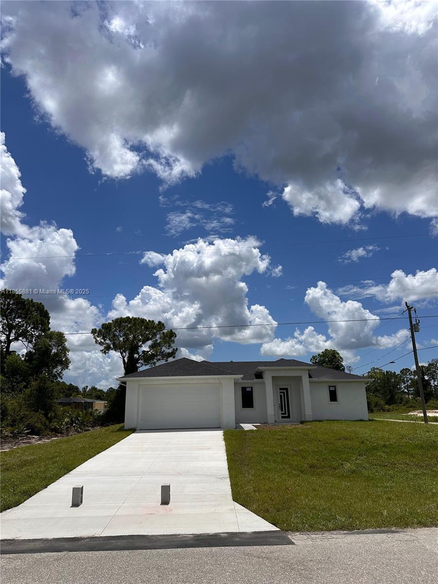 **Newly built home in the growing area of Lehigh Acres! This beautiful 3-bedroom, 2.5-bath property features an open-concept design with high ceilings, porcelain tile flooring, and impact-resistant windows and doors. The spacious kitchen is equipped with quartz countertops and stainless-steel appliances, seamlessly flowing into the living and dining areas — perfect for entertaining. The master suite offers a walk-in closet and a stylish bathroom for your comfort. Enjoy the convenience of a two-car garage providing ample parking and storage space. Built outside the flood zone for extra security. Colors and materials may vary depending on availability. Don't miss out — this home is easy to show and ready for you! Schedule your tour today and experience this stunning property firsthand!