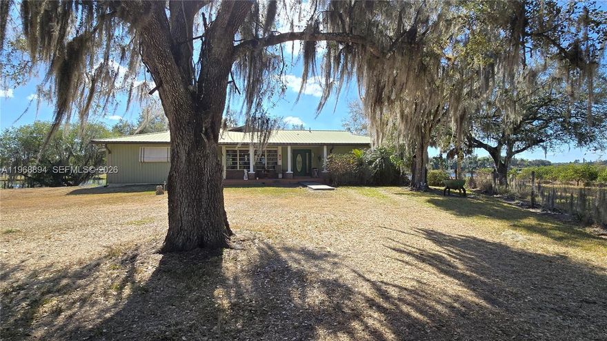 Navigate Florida's iconic waterways from Port St. Lucie on the Atlantic all the way to Fort Myers on the Gulf - right from your backyard. This impressive 4 bedroom 3 bath home offers 2985 SF of beautifully finished living space, plus an additional 2500 SF basement, currently used as a workshop with a view, but can easily be transformed into more living space, a guest suite, or a fully separate apartment. Set on 2.5 oak laden acres, the property also includes a 125' concrete slab, the perfect foundation for a Butler building, workshop, storage facility or future expansion. With 130 feet of pristine frontage on the Calooshatchee River, a boathouse and deck, you'll enjoy effortless access to the water and endless opportunities for adventure. And the views - sunrise to sunset, every single day - are nothing short of spectacular. Step outside to outdoor livng spaces galore, ideal for entertaining, relaxing, and soaking in the beauty of the riverfront lifestyle. A rare blend of space, freedom and waterfront living.