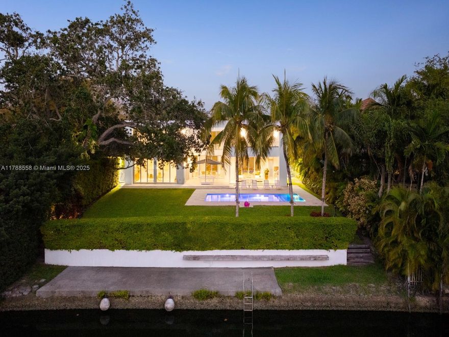 Exceptional waterfront residence with private dock on the Mahi Waterway offering direct access to Biscayne Bay. Designed for comfort and sophistication, featuring a spacious poolside entertainment area and expansive terraces off the upstairs bedrooms. The interior showcases a custom Mia Cucina kitchen with SubZero and Wolf appliances, and an outdoor kitchen ideal for hosting. Smart-home technology includes an Elan system, security cameras, and an alarm system. A 38KW full-house Kohler generator and 1,000-gallon in-ground propane tank provide peace of mind. Each bedroom offers a full en-suite bath and custom walk-in closet. Custom walnut cabinetry throughout and electric shades in the primary suite and main living areas. This home offers refined living inside and out.