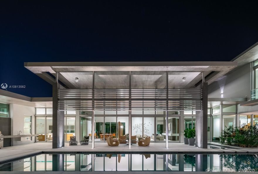 Modern and Mid-Century  marvel of custom architecture and engineering, flawlessly executed. Designed by KZ Architecture,  discover new wonders at every view: soaring ceilings, natural elements, glass framed views combine for a design that is anything but “white box.” Imagine yourself living in a work of art, enjoying your first floor master wing with, spa bath, private gated corner acre, reflection and heated pool and N/S tennis court. Home features poured in place cement roof with ceilings floating on beams, sculptural floating wood and glass staircase, LED lighting, and custom cabinetry. Great family/guest floor plan with upstairs loft and 3 suites. Staff room. Gym and office conv to bedroomms. More attached.