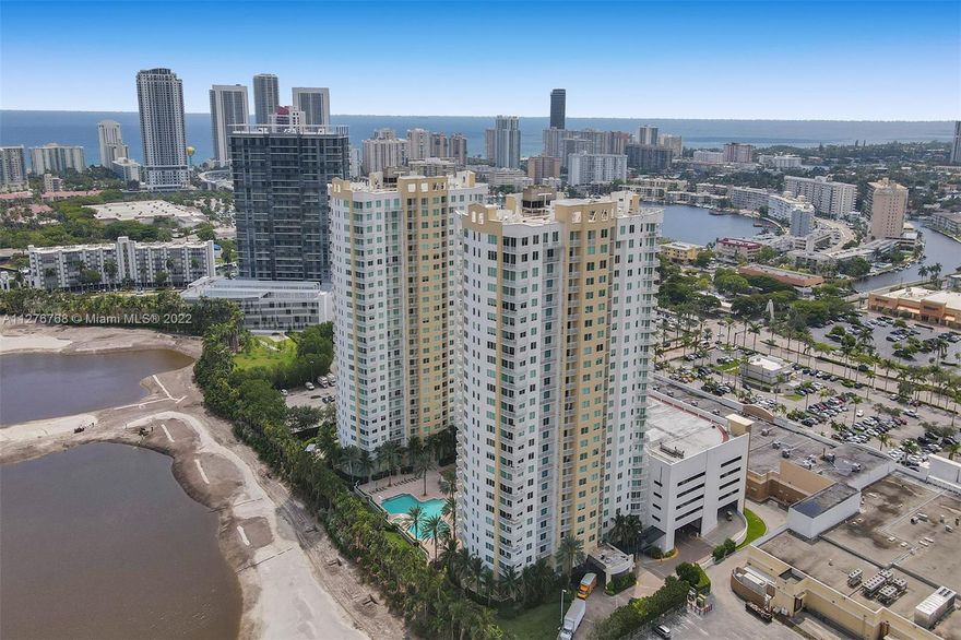 Beautiful lake and golf views, spacious interior streaming natural light, open kitchen, and resort style amenities in a condo near the beach and adjacent to shops, restaurants, Starbucks and more --welcome home to the Duo.  A home for vacation, full-time or investment, the corner condo has Travertine and oak wood floors, multiple large closets with two walk-in closets in the main bedroom, a full laundry room inside with more storage space. The kitchen has granite countertops, wood cabinetry, new Samsung appliances with dual oven stove, and island. Split bedroom floor plan with master suite one side, two more full bedrooms on the other. The Duo has 24-hour doorman, valet service, heated resort pool, tennis, billiards, theater, clubroom and more. Internet and cable included. Pets welcome.